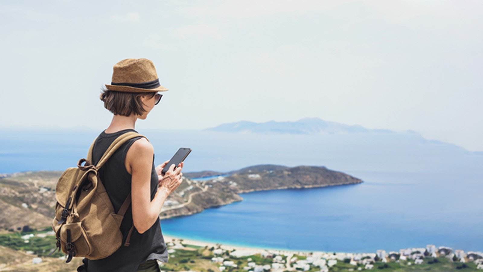 Woman with a phone in her hand near the sea