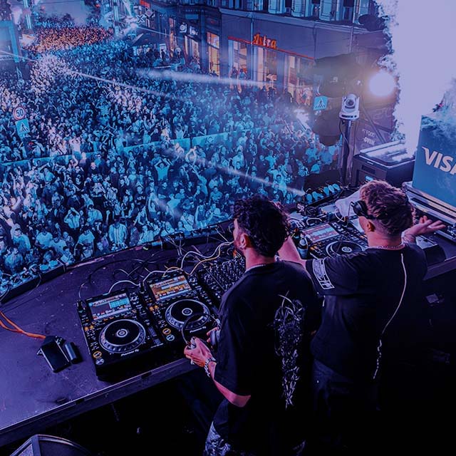 DJs play in front of the crowd